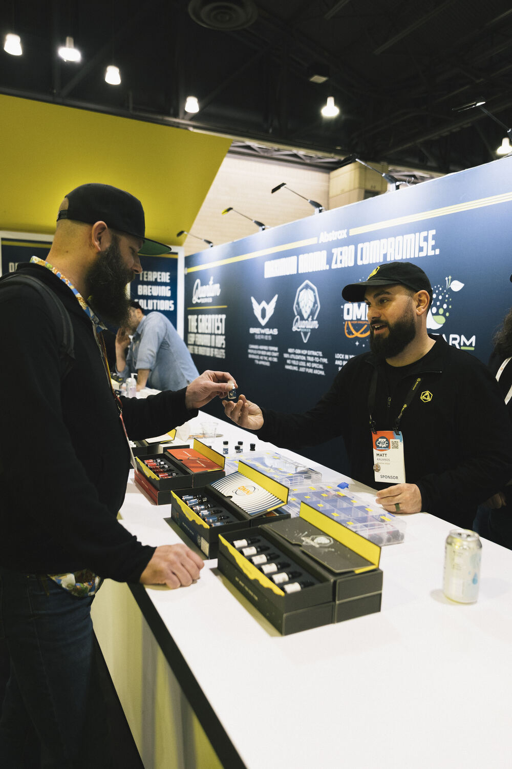 A CBC attendee speaking with the Abstrax Hops team at the Skunkworks Lounge