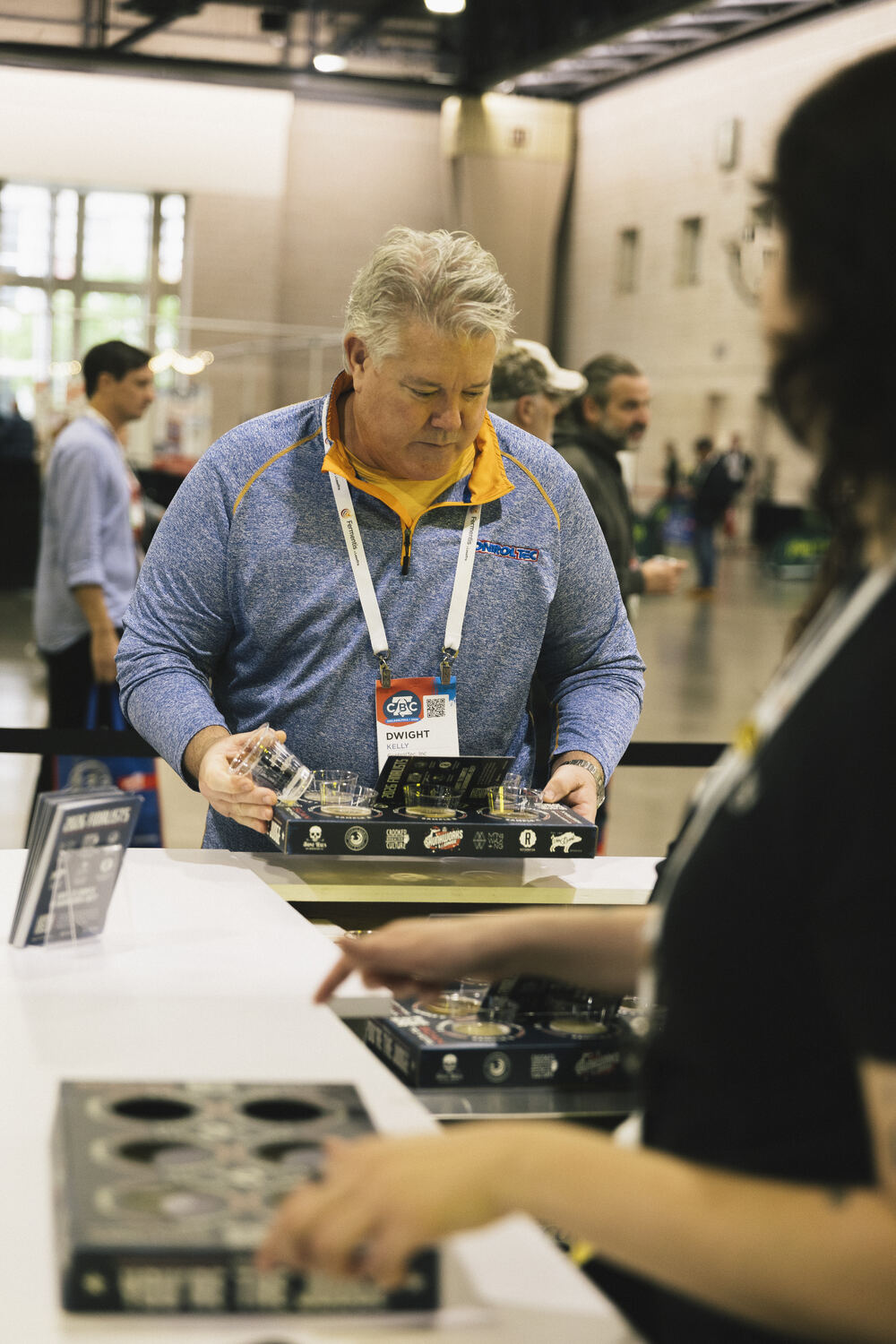A participant evaluating a blind beer flight at CBC 2026